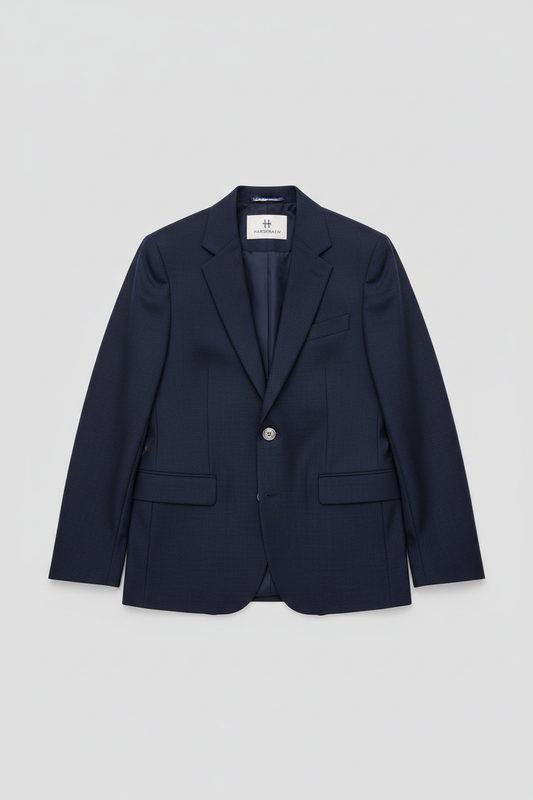 Modern navy blazer flat-laid on a clean light gray background